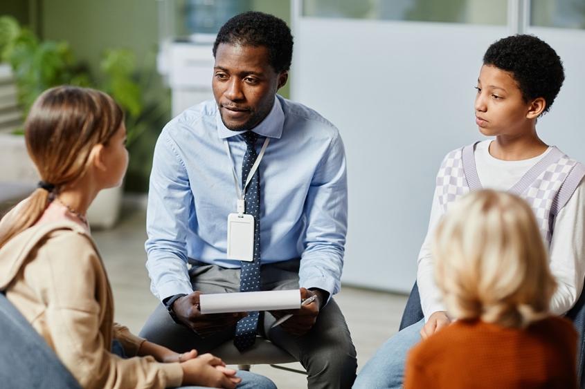 School psychologist meeting with a group of students